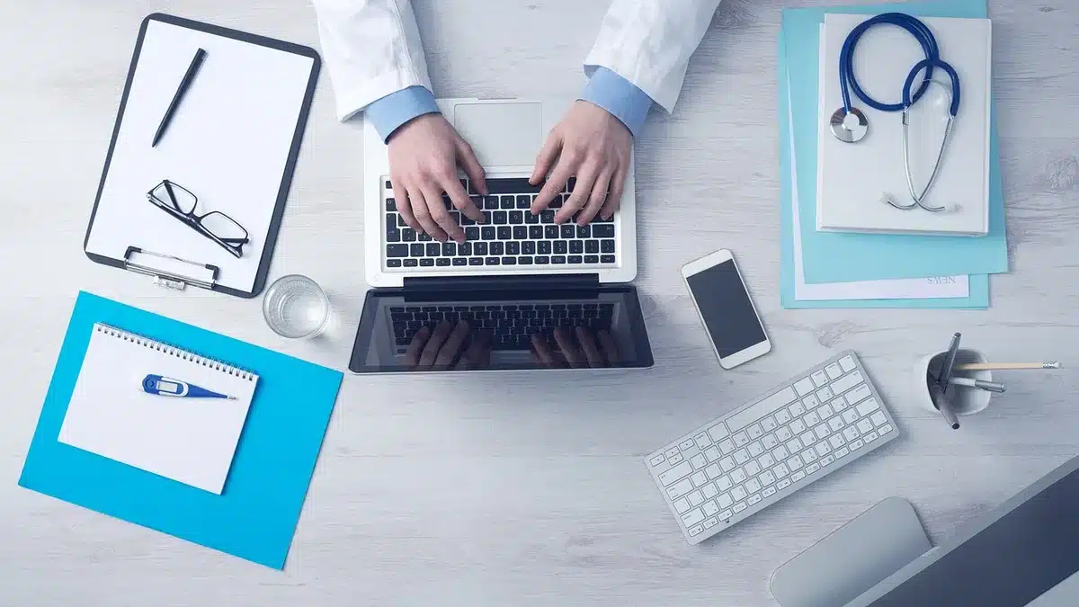 Bureau ensoleillé avec documents de création d'entreprise et ordinateur portable